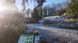 A frozen pond in the Japanese Garden in Avenham and Miller Park in Preston, Lancashire, UK