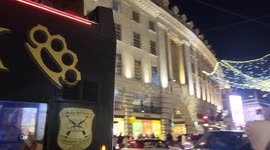 Angelic Christmas lights illuminate Regent Street, admired by tourists and Christmas shoppers