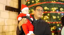 Christians in Gaza gather for the lighting up of the Christmas tree at Holy Family Church