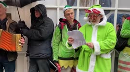 Bedraggled eco protesters sing lonely protest carols outside Coca-Cola store in London's Covent Garden