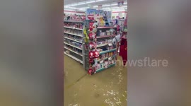 Shoppers wade though flooded supermarket amid storms in southern Thailand