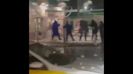 Moscow residents avoid stepping in puddle by climbing across fence