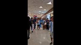 Argentina and France fans high five each other before the 2022 FIFA World Cup final in Qatar