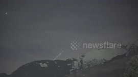 Starlink satellite train ascends into space above Swiss Alps