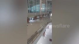 Storm sparks panic as it tears down gypsum wall at Indonesian airport