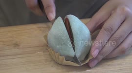 Thai sweets vendor prepares delicious Japanese dessert of strawberry-filled rice cakes