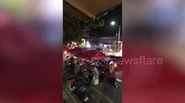 Strong wind batters market stall canopies during storm in the Philippines