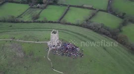Crowds gather at the Glastonbury Tor to celebrate the winter solstice