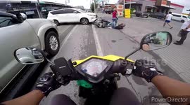 Scooter rider and pillion passenger topple over after being hit by sedan