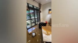 Muddy flood overturns resident's furniture as torrential rains hammer Malaysia