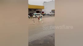 Locals use surf board on flooded raid following heavy rain in southern Thailand