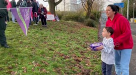 Little boy gives present to strikers in Manchester, UK
