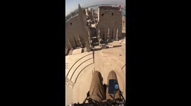 Paramotor pilot glides over the ancient Luxor Temple in Egypt *AWE-STRIKING*