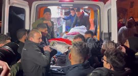 Mourners carry the body of Palestinian young woman Maha Zaatari who was killed by Israeli forces in April during her funeral, in the West Bank city of Hebron.