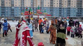 Santa Claus entertains children outside apartment block in St Petersburg, Russia