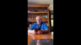 Dad in delight after receiving a new puppy as a retirement gift from daughter