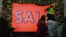 Oh no, is it all over already?: Workers spotted covering Selfridges Christmas window displays in Oxford Street with sale signs