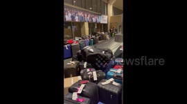Baggage piled up at airports as flights across the country are cancelled due to severe weather