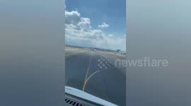 Loose wheel rolls across tarmac at airport in Mexico