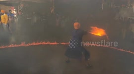 Sword fighting and fire stunts during celebration of Prakash Parv in India