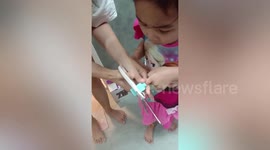 Worried mum cut building blocks toy stuck on daughter’s finger using scissors
