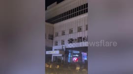 Stranded people climb from casino windows as fire kills at least 10 in Cambodia