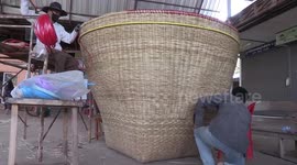 Locals weave giant bamboo basket for storing rice