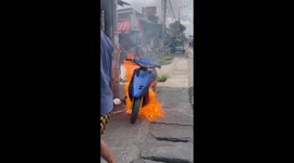 A motorcycle starts a massive fire on the side of the road!