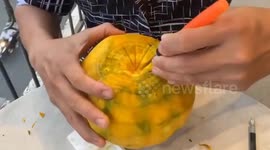 Vietnamese chef sculpting beautiful 3D flowers on a pumpkin
