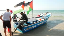 Palestinians dressed as Santa Claus during the sailing and rowing  show on the shore of the Mediterranean