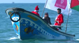 Surfers wear Santa Claus costumes to go jet skiing in Gaza
