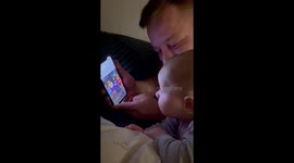 Baby boy enjoys watching women bouncing their boobs on dad's phone