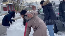 People digging out cars of snow in Buffalo, New York, US