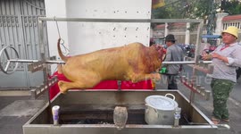 Locals spit roast hog for New Year celebrations in Cambodia