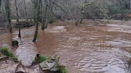 River plym and the disused canal bursting its banks with the heavy rain full Newyears Eve Plymouth Devon uk