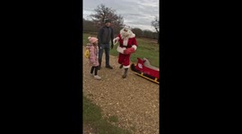 'Santa Cruise' hands out presents to kids in London while riding an electric sleigh