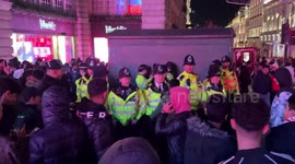 Police arrest a man during New Year's 2023 celebrations in Piccadilly Circus