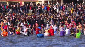 Crowds gather to cheer on new years day dippers at a North Yorkshire seaside town.