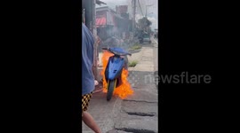 A motorcycle starts a massive fire on the side of the road in Nueva Ecija, Philippines