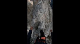 Nerve-rattling reel shows mountain adventurer walking on sharp, narrow ridge