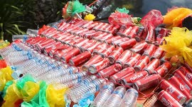 Locals cover their cars in recycled plastic bottles and drinks cans for climate change event