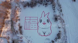Chinese farmer paints giant rabbit in snow to welcome new year
