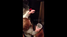 Cute toddler just can't work out the water dispenser