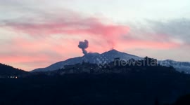 Beautiful red sunset over erupting volcano
