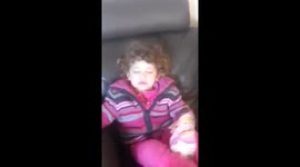 Lazy toddler shows its alright to lie on the couch and eat crisps