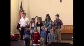 Distracted child disrupts Christmas singing service