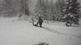 Man ploughs through deep snow in Canada