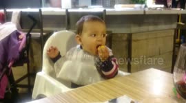 Baby pulling a funny face after eating a lemon