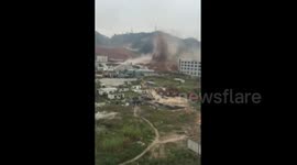 Long shot of landslide hitting industrial park in Shenzen, China,