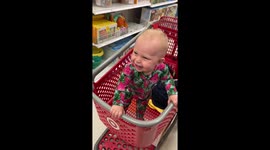 Full-of-life baby girl laughs her heart out while watching mama hula-hooping